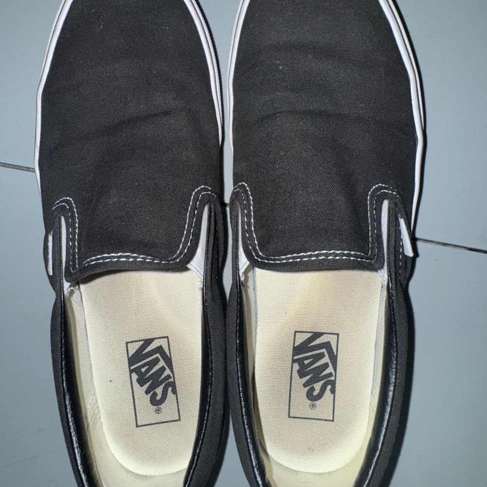 Men’s black slip on vans.
